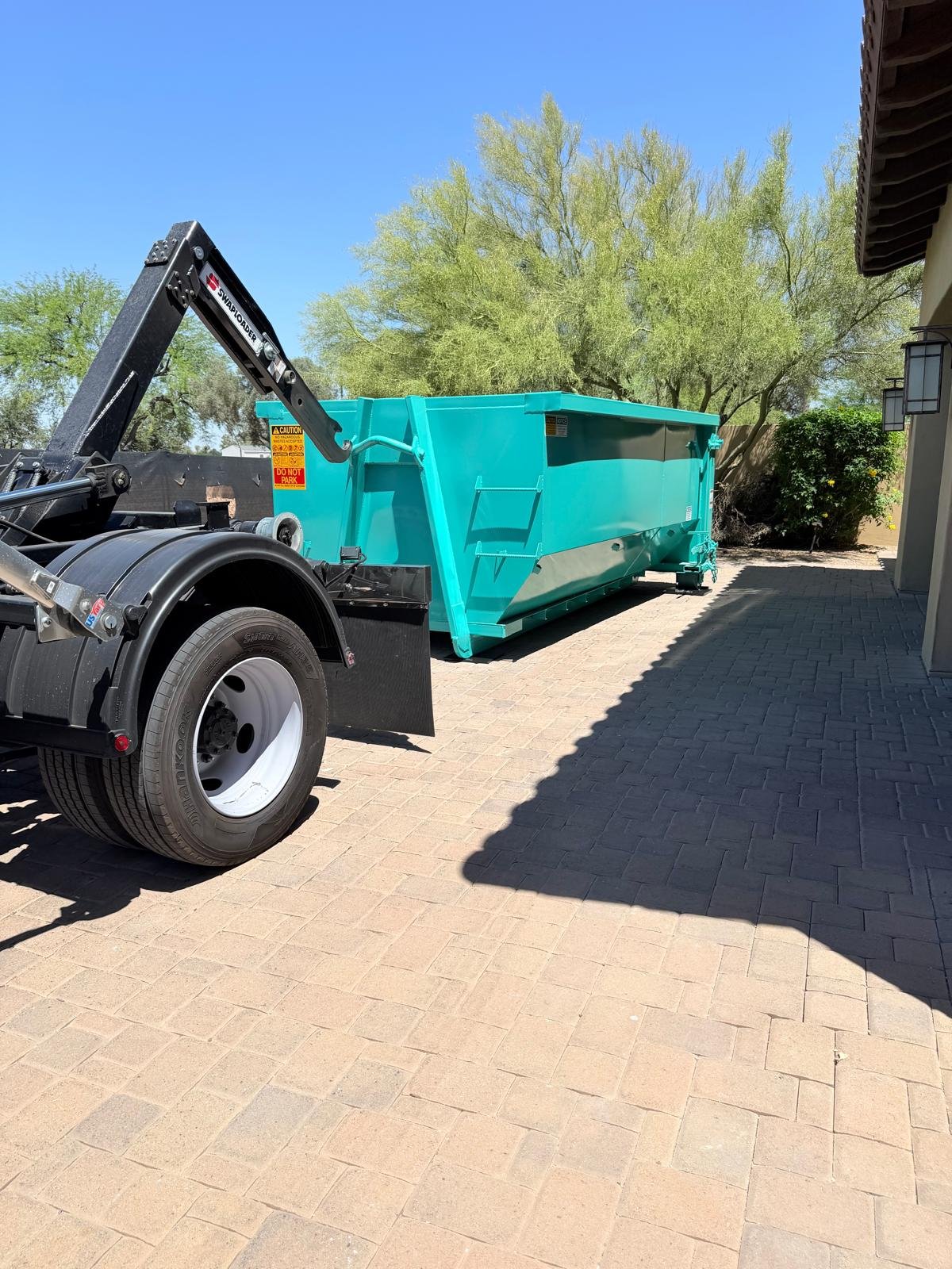 15-yard roll-off dumpster delivered for a estate cleanout project on a residential driveway in the East Valley, Arizona